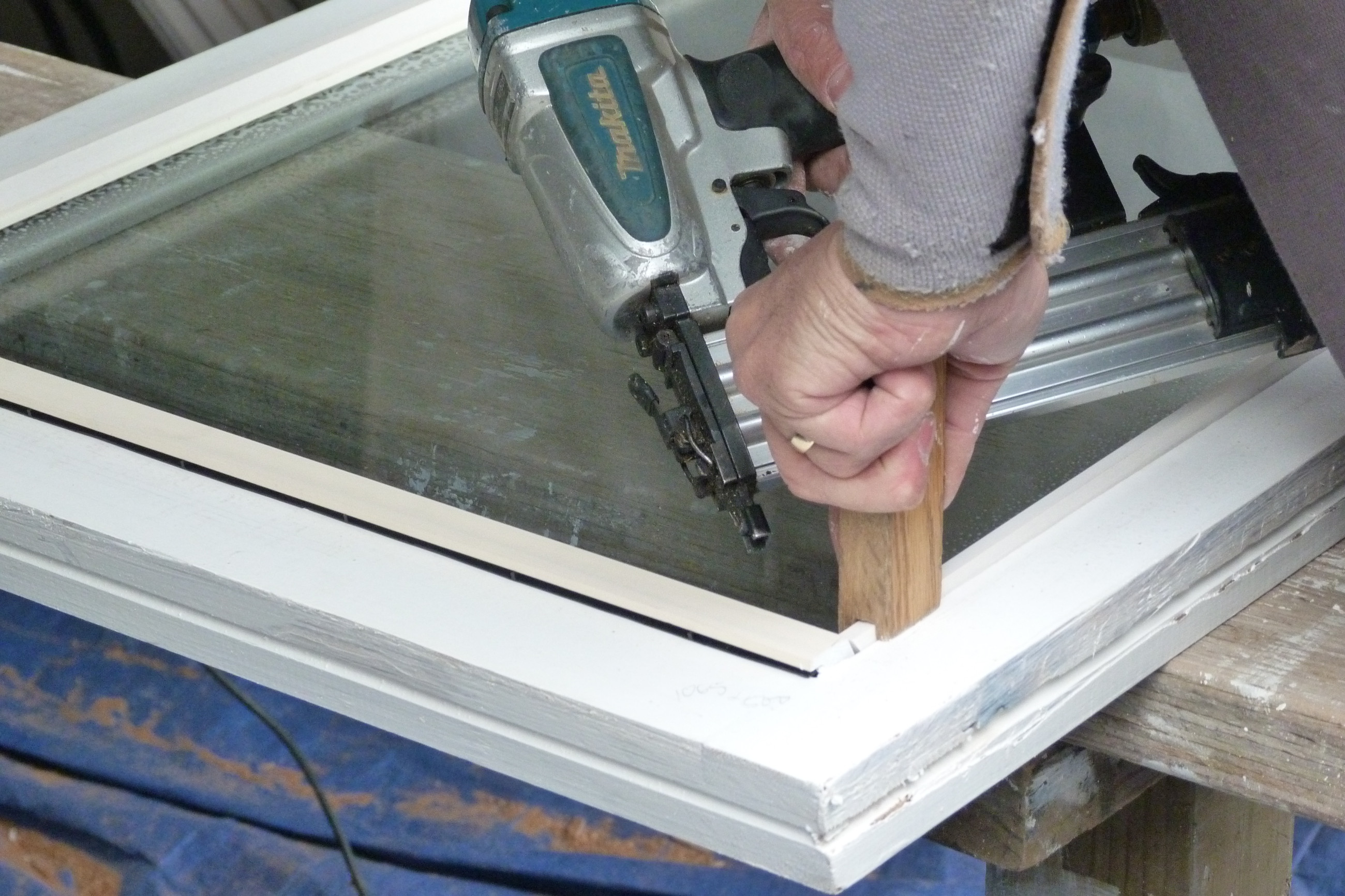 Double glazed windows being installed in timber framed