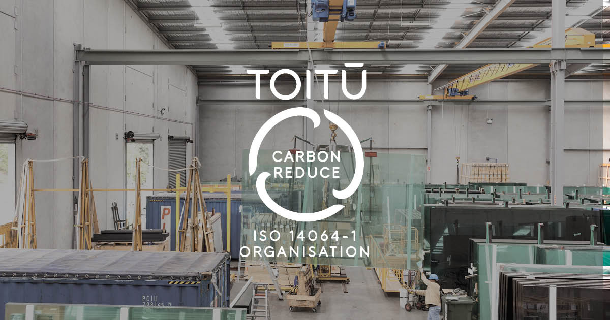 Factory workshop with Toitu logo in front