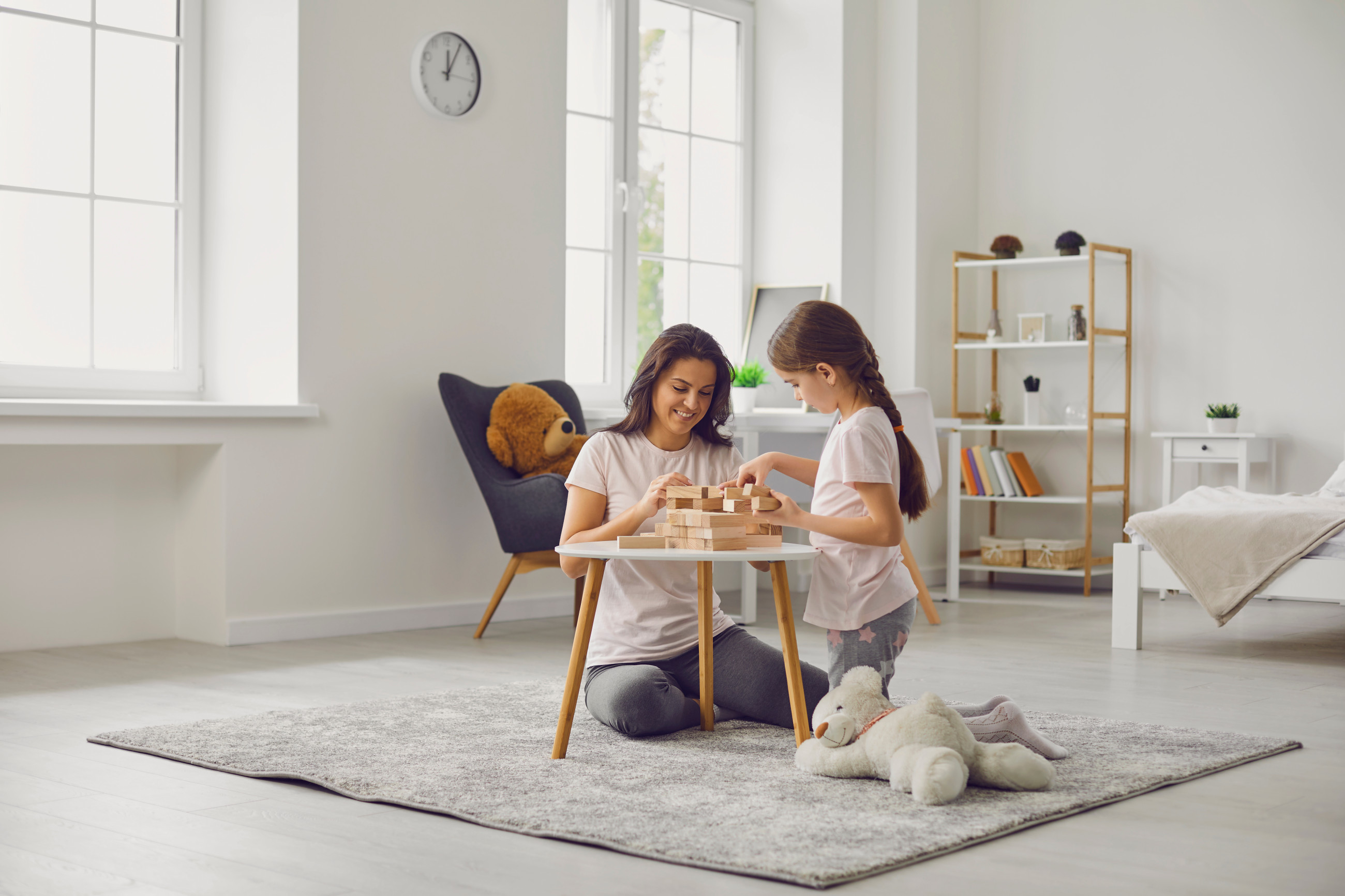 Mother and daughter playing in living room