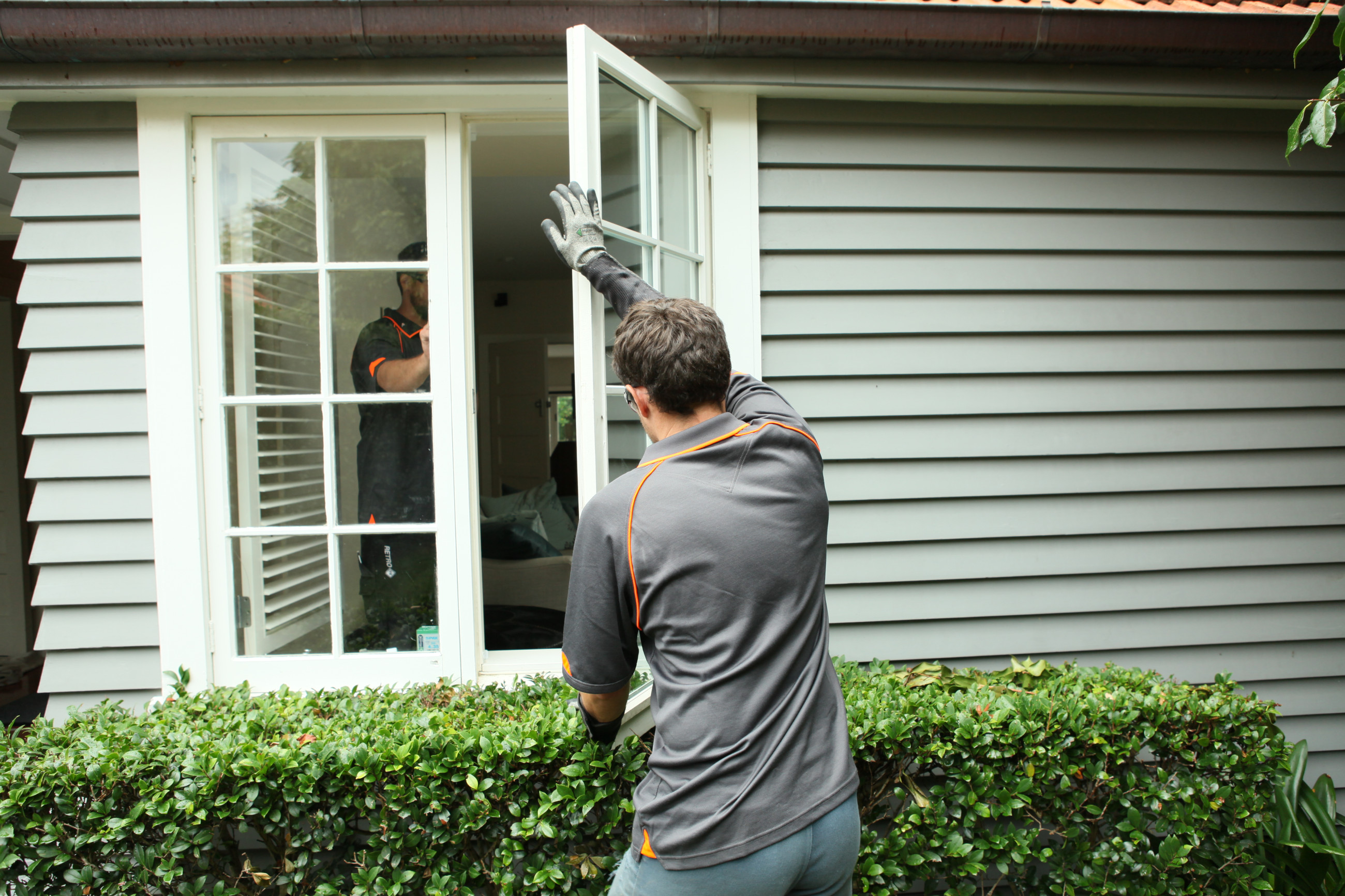 RetroFit DG employee installing a double glazed window in timber frames