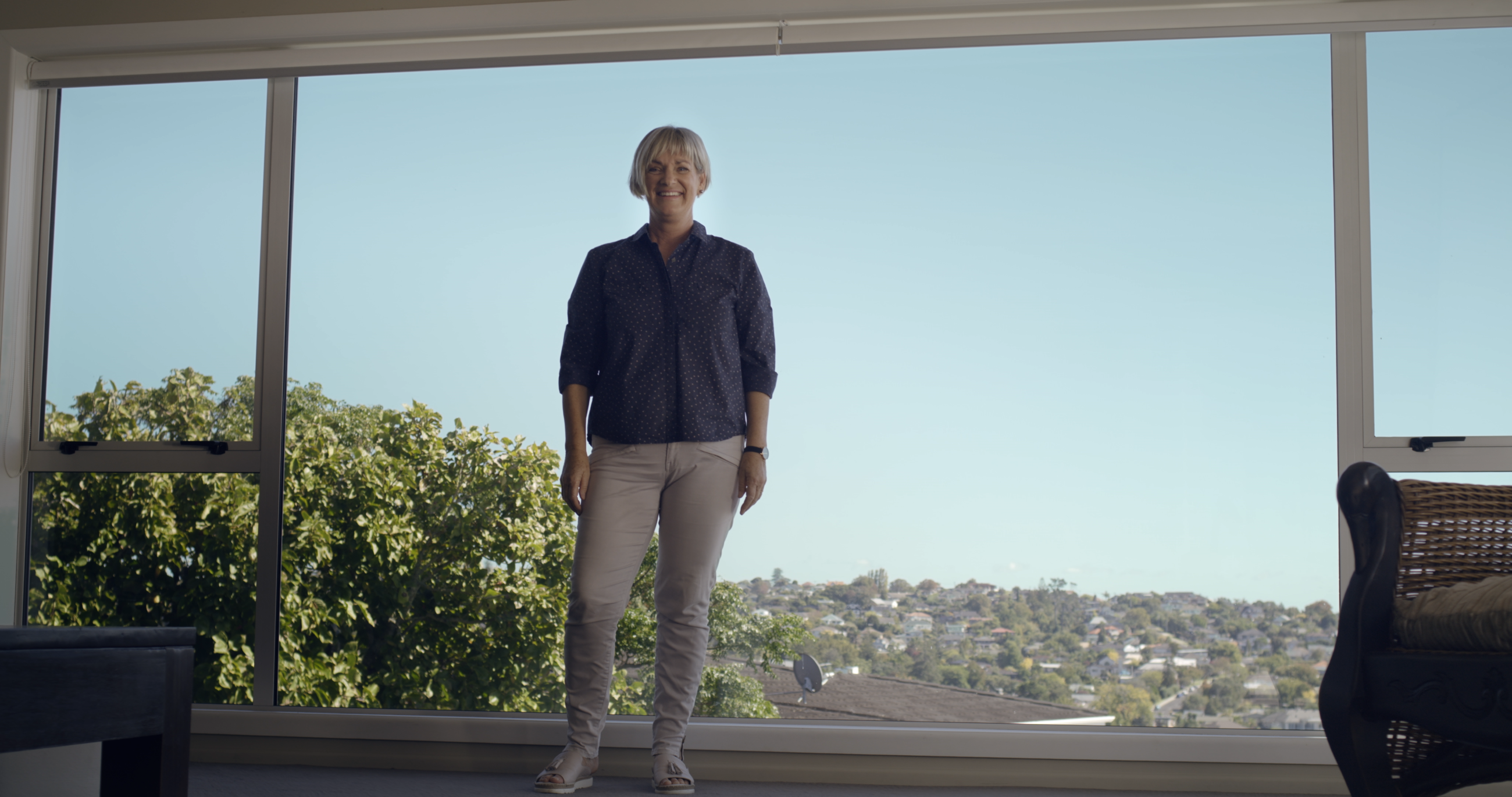 A women standing in front of large double glazed windows